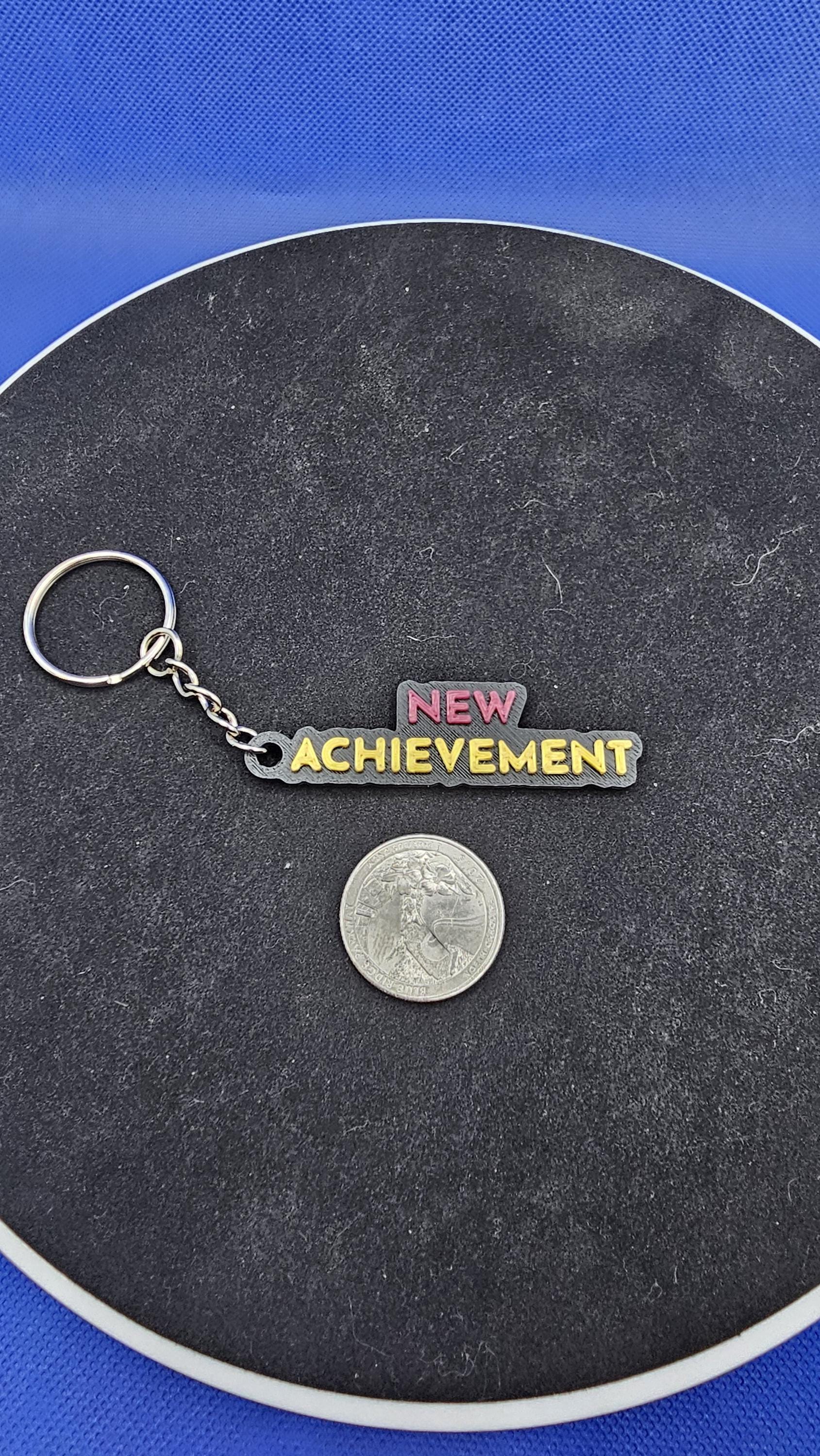 Dungeon Crawler Carl Quote Keychain – “New Achievement” – Keychain – Fantasy Book Gift